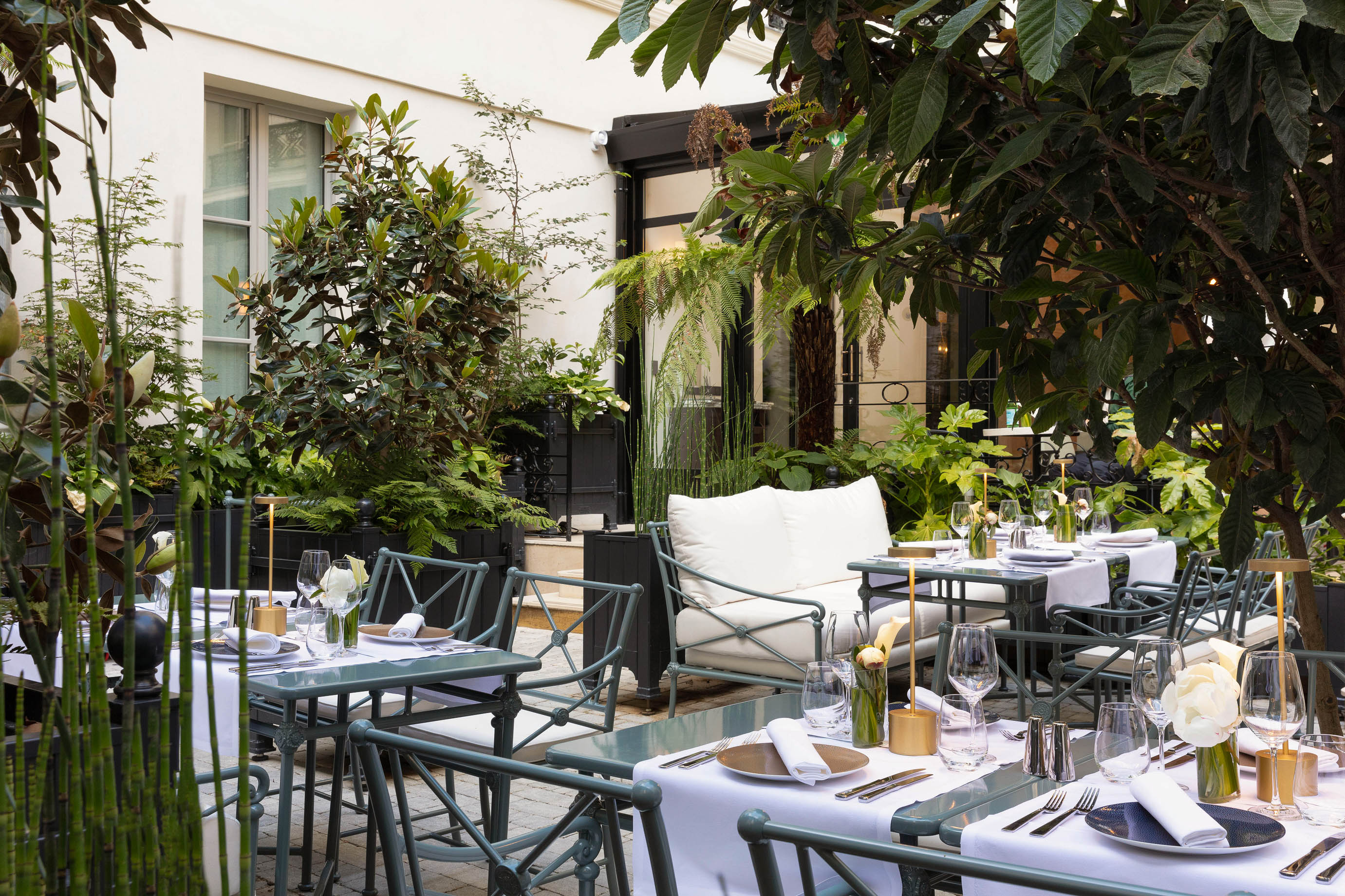 Terrace and garden of the 5-star boutique hotel Les Jardins du Faubourg, close to the Champs-Elysées